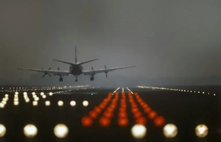 Airplane landing on a runway at dusk